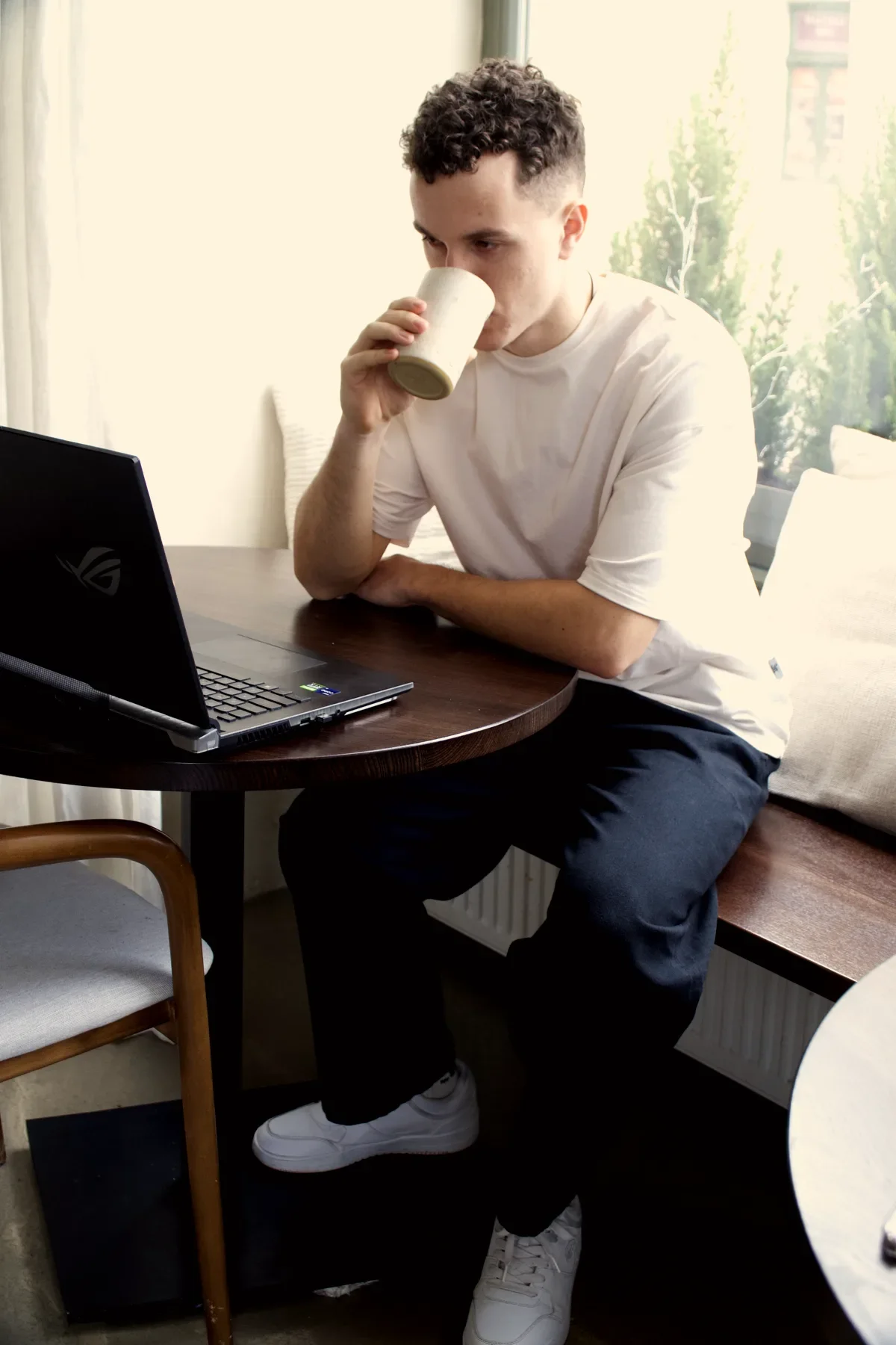 Mykhailo working on a laptop in a café
