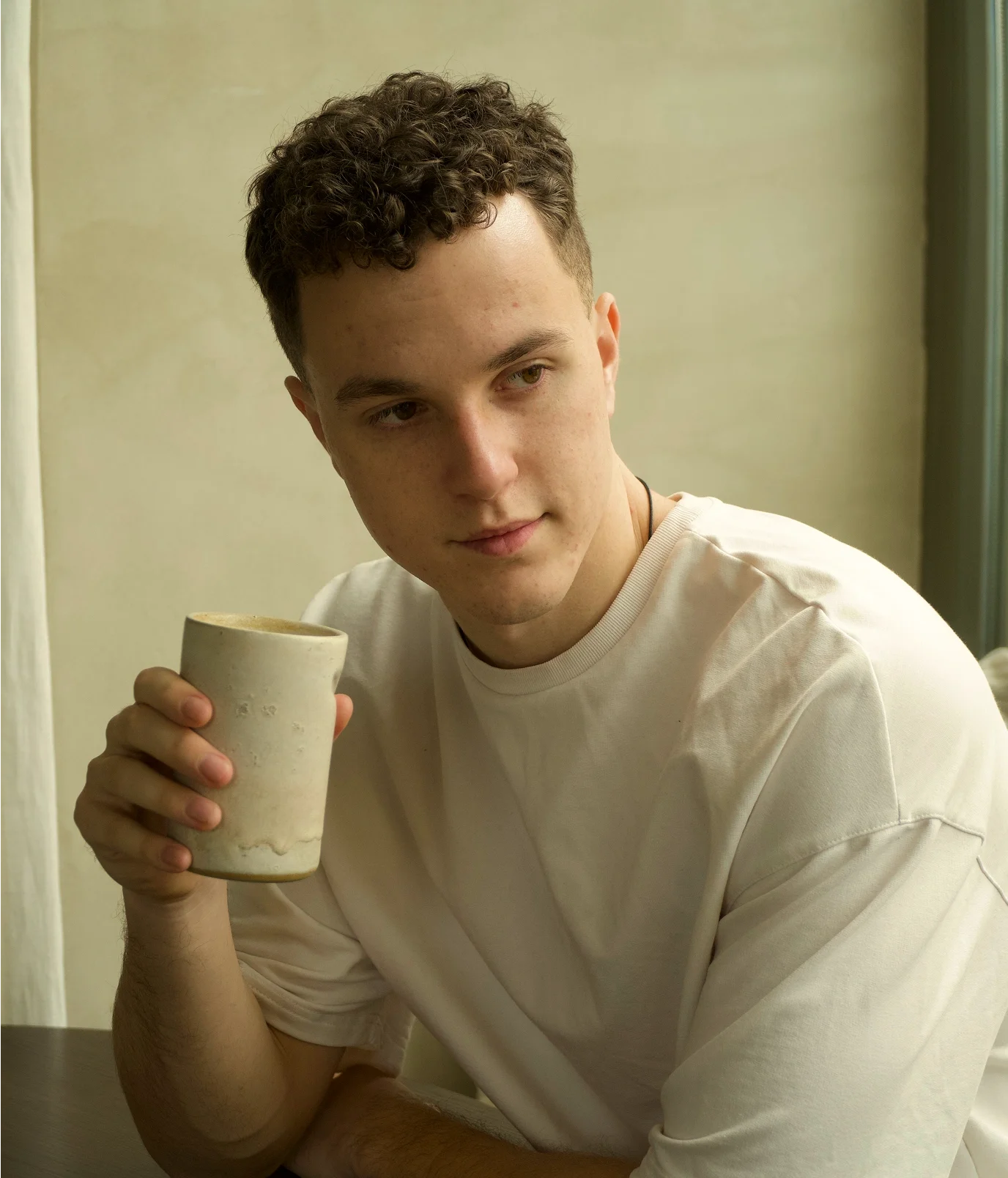 Mykhailo Riabokon with a cup of coffee in a café